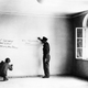 FILE - In this June 14, 1945 file photo a couple of American soldiers write their names on the wall of the bedroom where Adolf Hitler was born in Braunau, Austria. It took nearly a century _ but Adolf Hitler is now formally persona non grata in the town of his birth. Braunau town council's unanimous decision to withdraw honorary citizenship from the community's most infamous son came 78 years after the Nazi dictator was given the title. (AP Photo/Pool/INP)